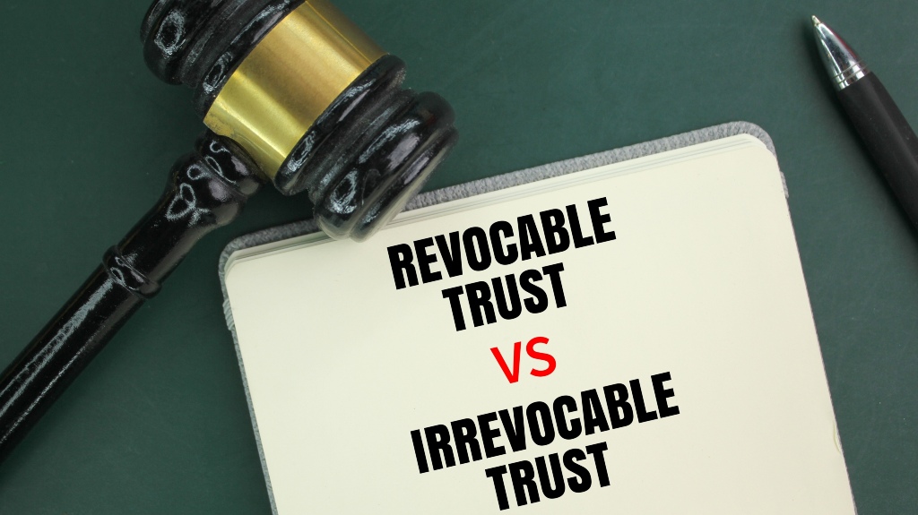 Judge's hammer, pen and book with the words Irrevocable Trust vs Revocable Trust