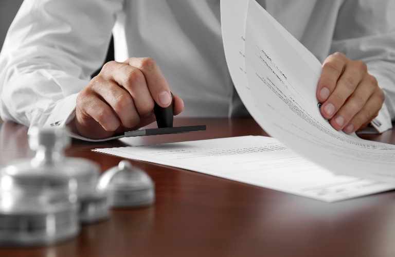 notary is putting stamp on the document